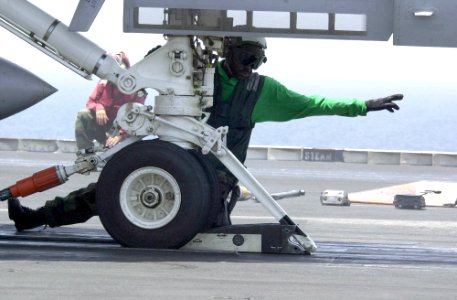 US Navy 030625-N-9319H-005 A Nimitz crewmember prepares an F-A-18 Hornet for launch on one of four steam driven catapults on the flight deck aboard USS Nimitz (CVN 68)