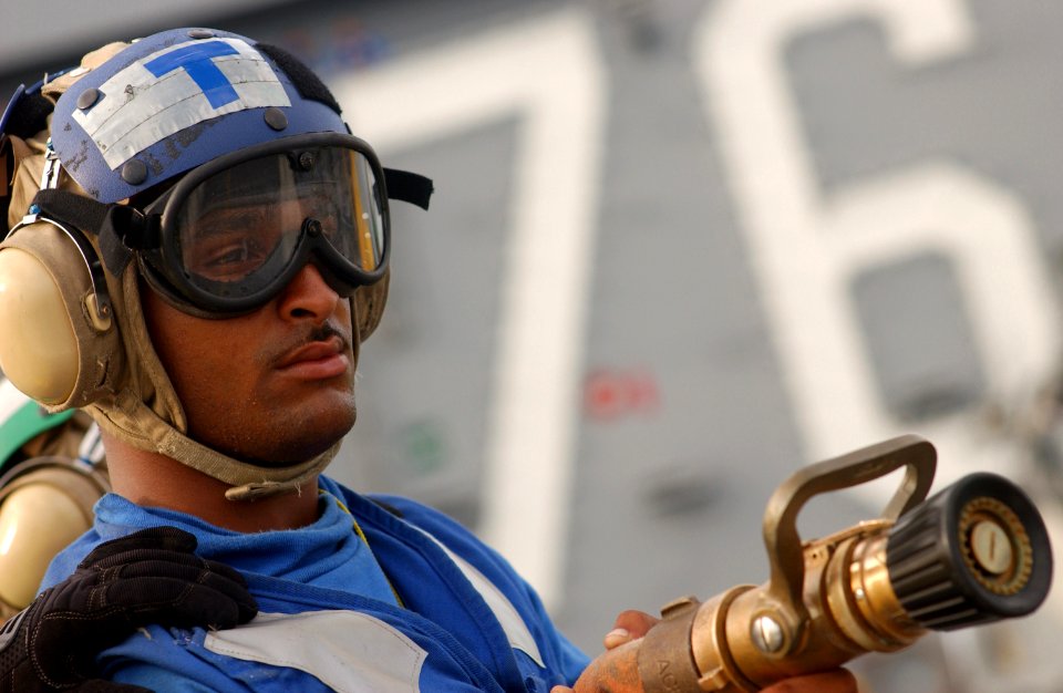 US Navy 030724-N-0696M-075 Airman Terrance Flournoy mans a fire hose during a flight deck fire drill aboard USS Ronald Reagan (CVN 76)