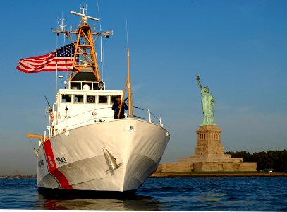 US Navy 030828-C-5313L-543 U.S. Coast Guard Cutter Bainbridge Island (WPB 1343), home ported in Sandy Hook, NJ., stands watch over the Statue of Liberty in New York Harbor
