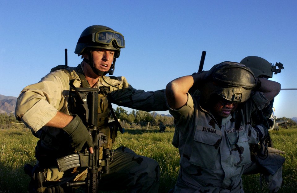 US Navy 030806-F-7823A-003 U.S. Navy SEAL (Sea, Air and Land) Team members secure a downed pilot for extraction at Naval Air Station