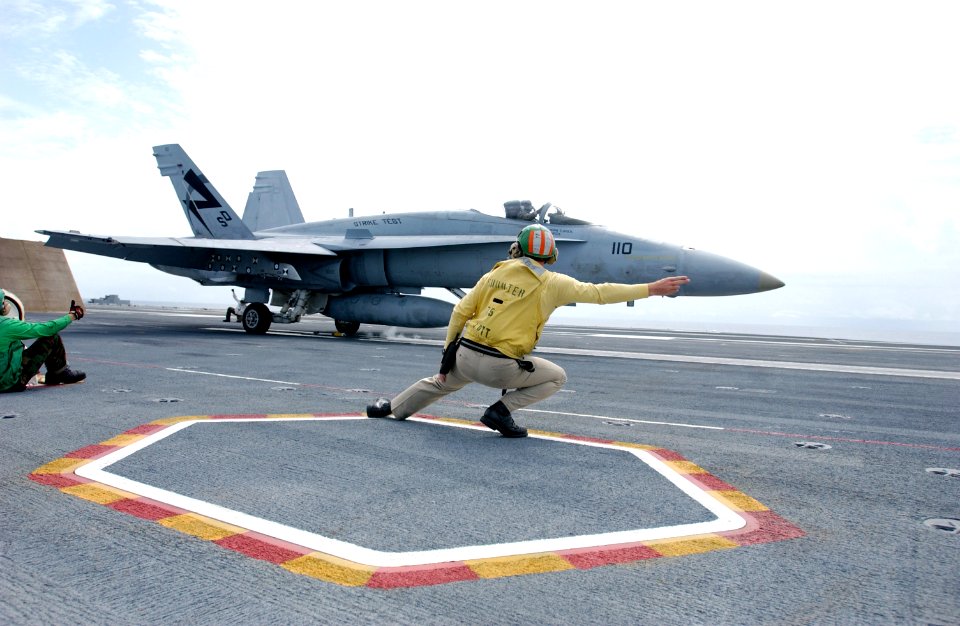 US Navy 030726-N-0696M-007 Lt. Benjamin VanBuskirk gives the signal to launch an F-A-18 Hornet