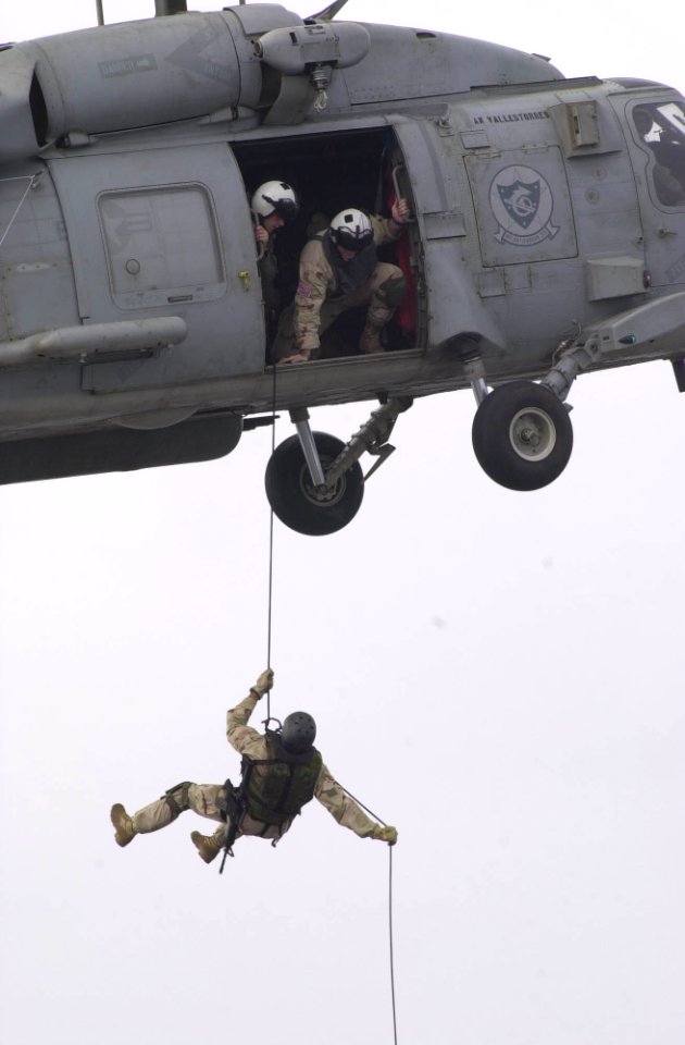 US Navy 030824-N-1577S-003 Aircrew Survival Equipmentman 1st Class Matt Broderson, from Cedar Rapids, Iowa, a member of Explosive Ordnance Disposal Mobile Unit Eleven, Detachment One (EODMU-1, DET 1), rappels from an SH-60 Seah