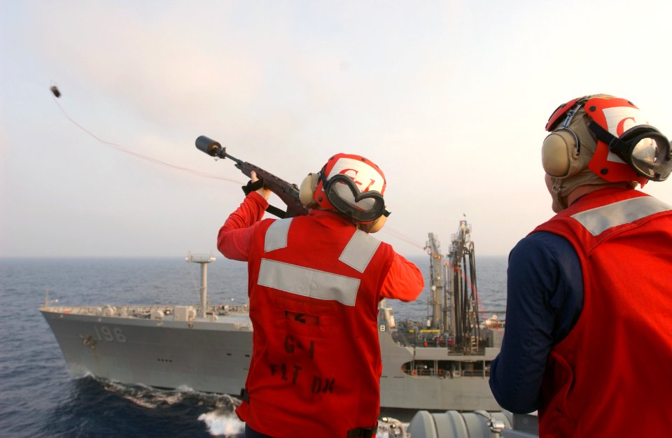 US Navy 030729-N-0696M-059 Gunner's Mate Seaman Kyle Suthers fires the first shot line to the Military Sealift Command oiler USNS Kanawha (T-AO 196) during the first underway replenishment (UNREP) with USS Ronald Reagan (