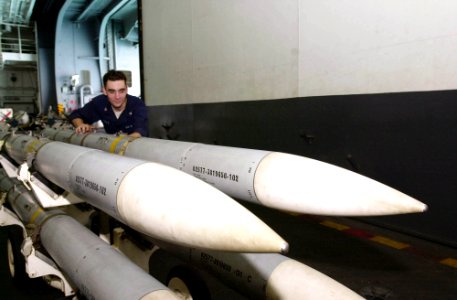 US Navy 030611-N-2143T-002 Aviation Ordnanceman 3rd Class Sean Foley from Philadelphia, Pa., moves Air Interceptor Missile 120 (AIM-120) to a weapons elevator for transfer to the flight deck aboard USS Nimitz (CVN 68) photo