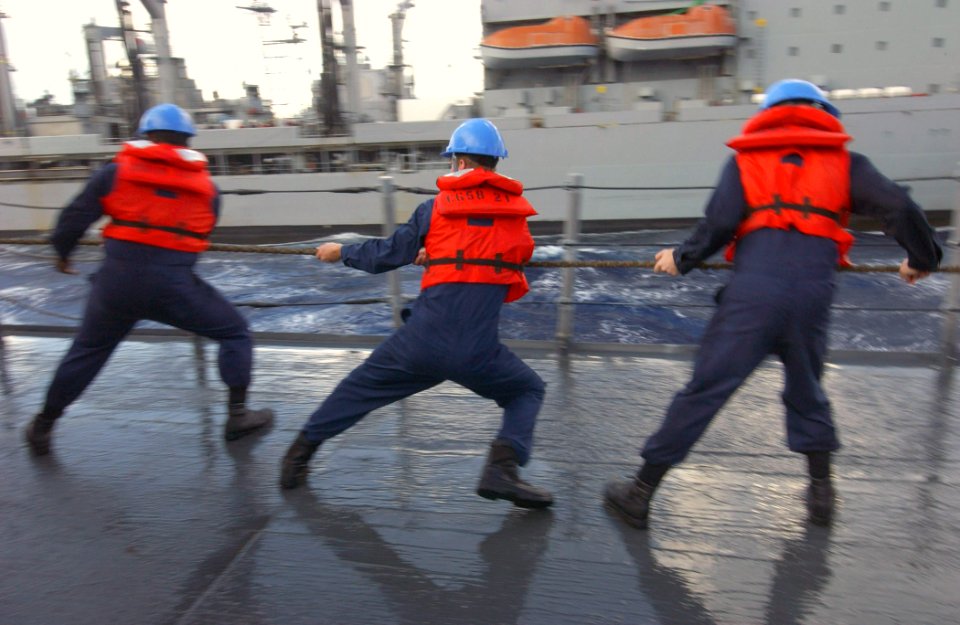 US Navy 030904-N-5471P-007 Sailors aboard the guided missile cruiser USS Philippine Sea (CG 58) heave around on a line during a replenishment-at-sea with the USNS Kanawha (T-AO 196) while underway in the Atlantic Ocean