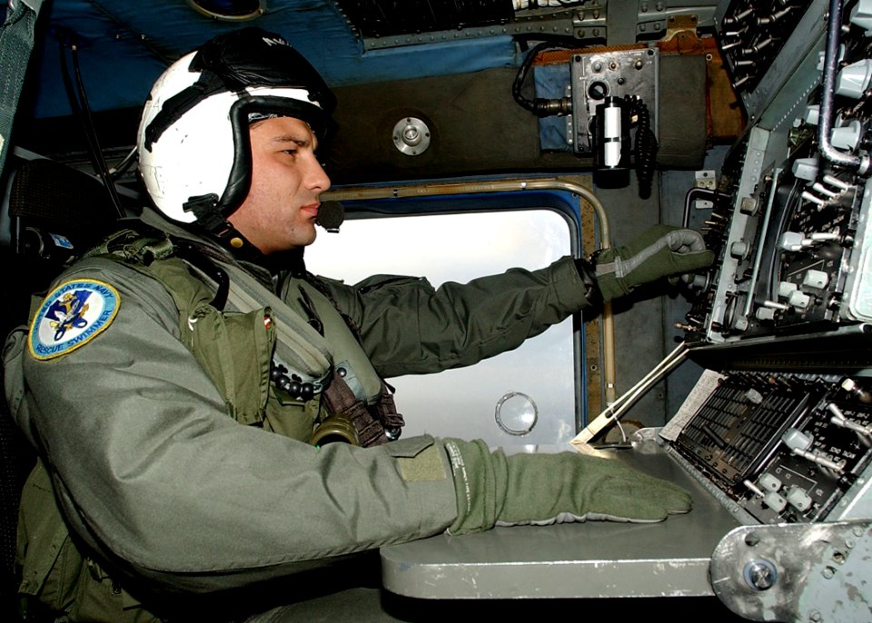 US Navy 030611-N-4374S-007 Aviation Warfare Systems Operator 2nd Class Heath Moore tracks a submarine contact aboard an SH-60B Seahawk during a anti-submarine warfare flight mission