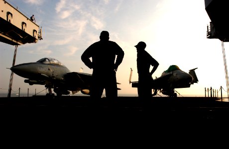 US Navy 030709-N-0696M-015 Sailors prepare to raise an F-14 Tomcat and F-A-18 Hornet to the flight deck on one of the ship's aircraft elevators, to be used as static displays on the flight deck during the ceremony