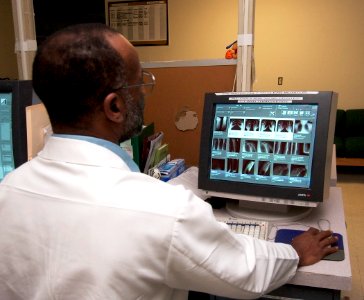 US Navy 030820-N-9593R-018 Lead x-ray technologist, James Crisler checks a group of recent x-rays on the monitor in the radiology department