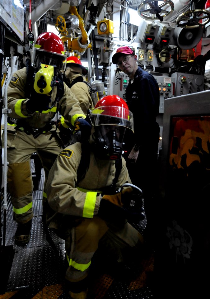 US Navy 100513-N-7280V-209 Sailors use a Naval Firefighting Thermal Imager (NFTI) to asses a simulated fire