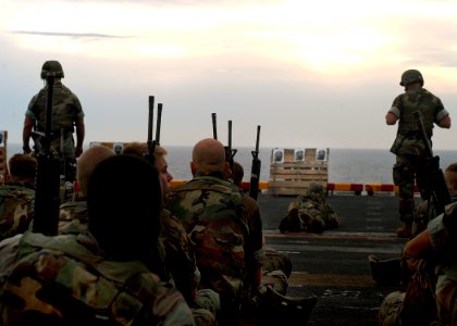 US Navy 030615-N-2819P-001 Marines assigned to 3rd Battalion 2nd Marine Regiment (3-2) participate in a small arms shoot on the flight deck aboard the amphibious assault ship USS Kearsarge (LHD 3)