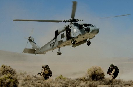 US Navy 030806-F-5435R-023 A HH-60H Seahawk helicopter departs after delivering Navy SEAL (Sea, Air and Land) Team members