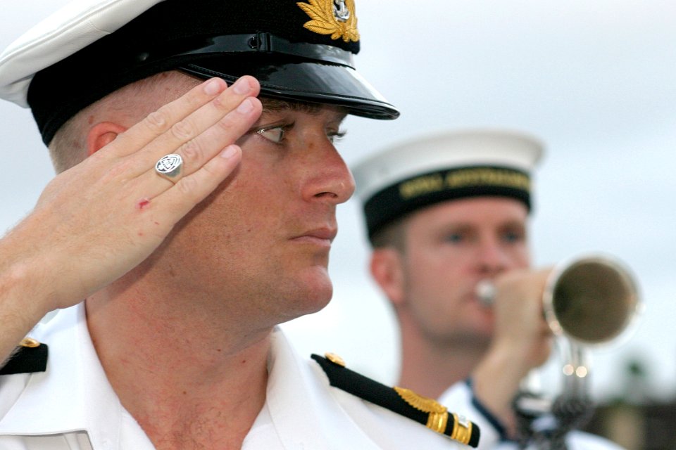 US Navy 030901-N-3228G-002 A Royal Australian Navy Lt. renders honor to a U.S. Navy flag officer