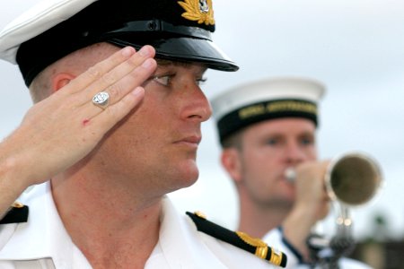 US Navy 030901-N-3228G-002 A Royal Australian Navy Lt. renders honor to a U.S. Navy flag officer