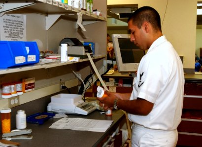 US Navy 030819-N-9593R-104 Hospital Corpsman 3rd Class Michael Dominguez, of Denver, CO., labels a prescription in the pharmacy at the National Naval Medical Center in Bethesda, Maryland
