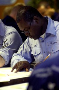 US Navy 030904-N-1577S-002 While taking the Navy 1st Class Petty Officer advancement exam aboard USS Nimitz (CVN 68), a sailor reviews a question before choosing an answer photo