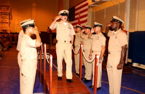 US Navy 030915-N-6803B-061 Chief Electronics Technician Michael Mihok walks across a brow as sideboys render honors