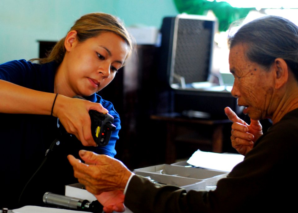 US Navy 100606-N-5207L-227 Lt. Thuong Le cans a Vietnamese patient's wristband during a Pacific Partnership 2010 medical civic action program