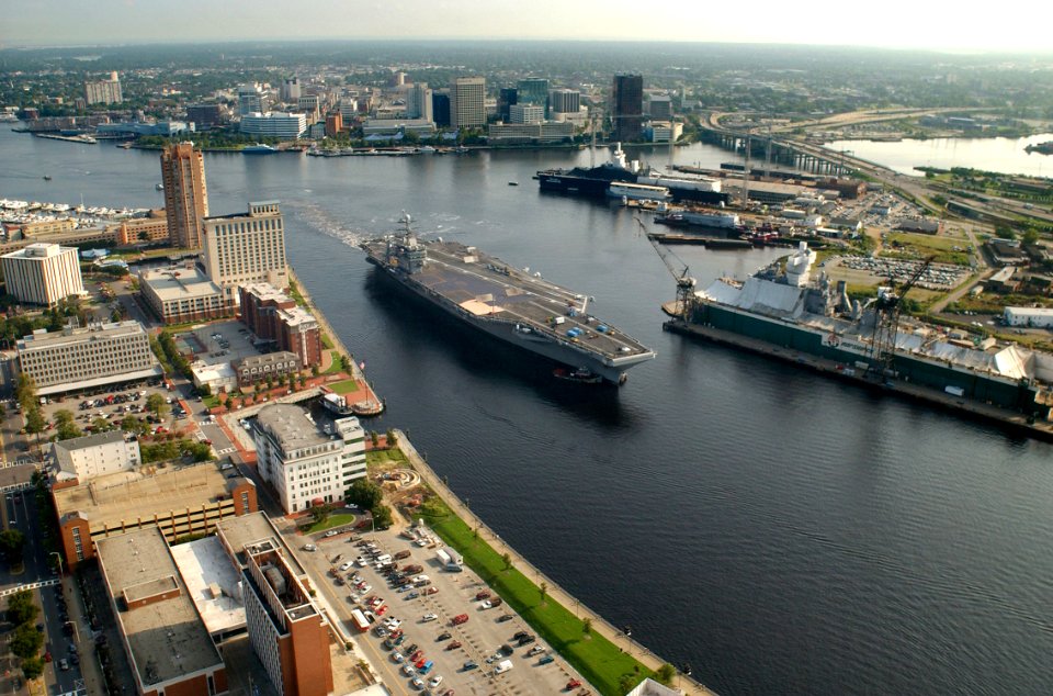 US Navy 030820-N-9851B-018 Tug boats guide USS Harry S. Truman (CVN 75) up the Elizabeth River, past Portsmouth landmarks, to the Norfolk Naval Shipyard