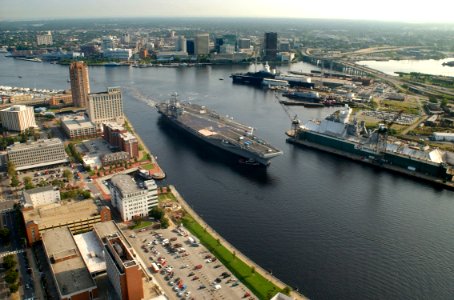 US Navy 030820-N-9851B-018 Tug boats guide USS Harry S. Truman (CVN 75) up the Elizabeth River, past Portsmouth landmarks, to the Norfolk Naval Shipyard