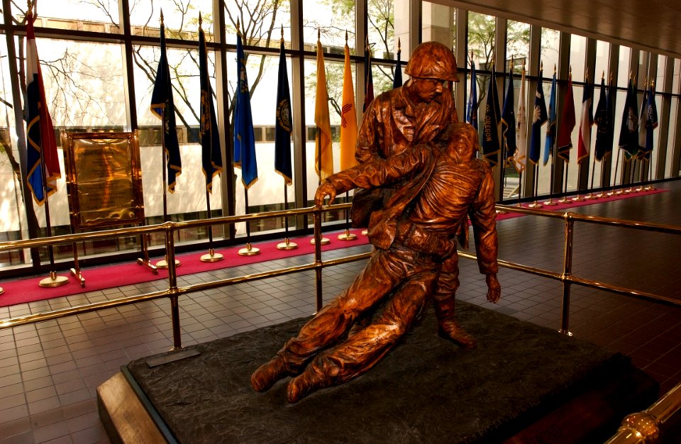 US Navy 030819-N-9593R-191 The bronze statue, depicting the bond between Navy hospital corpsmen and U.S. Marines, stands in the main lobby at the National Naval Medical Center in Bethesda, Maryland