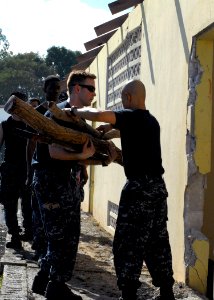 US Navy 100127-N-4971L-119 Sailors elp local missionaries clear out a destroyed building