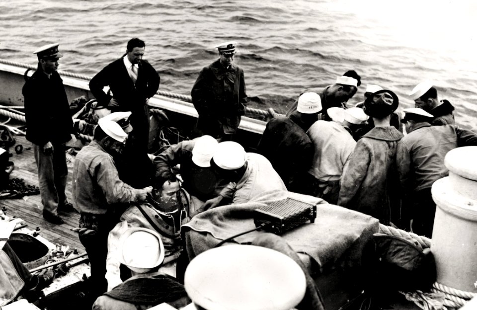 US Navy 030808-N-0000X-002 Cdr. Charles 'Swede' Momsen stands next to the rail (third from left) as USS Falcon (ASR 2) crewmen suit-up two Deep Sea Divers