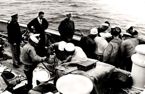 US Navy 030808-N-0000X-002 Cdr. Charles 'Swede' Momsen stands next to the rail (third from left) as USS Falcon (ASR 2) crewmen suit-up two Deep Sea Divers