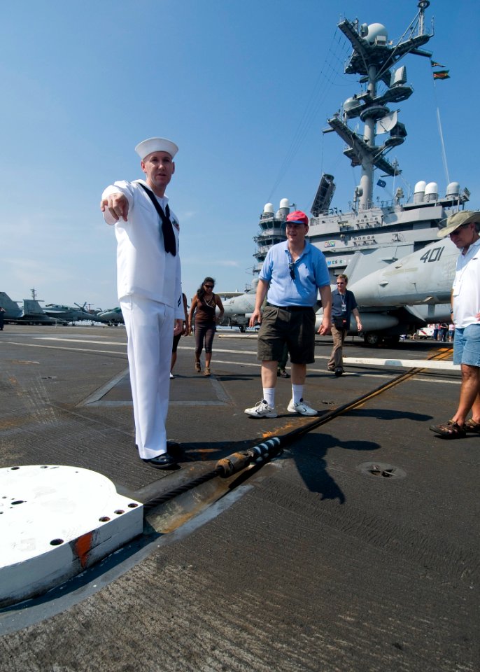 US Navy 100905-N-0754Y-033 viation Boatswain's Mate (Equipment) 1st Class Sean Valis explains the function of the arresting gear on the flight deck