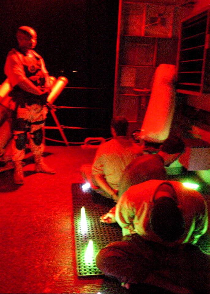 US Navy 030929-C-3550N-005 Members of coalition forces question one of four suspected sea-faring bandits aboard USS Firebolt (PC 10), in the North Arabian Gulf