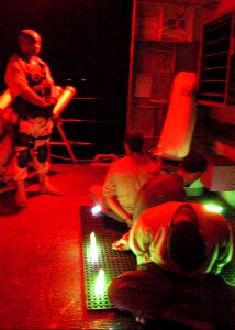 US Navy 030929-C-3550N-005 Members of coalition forces question one of four suspected sea-faring bandits aboard USS Firebolt (PC 10), in the North Arabian Gulf
