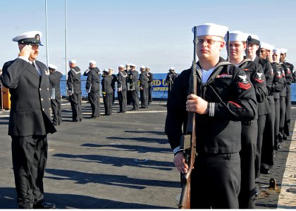US Navy 100210-N-1082Z-085 Sailors stand in formation during a burial at sea aboard USS Ashland (LSD 48) photo