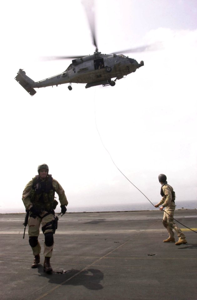 US Navy 030824-N-6536T-011 A SH-60 Seahawk helicopter assigned to the Indians of Helicopter Anti-Submarine Warfare Squadron Six (HS-6), hovers during a fast-roping drill