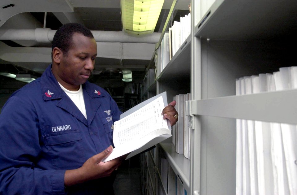 US Navy 030630-N-1577S-002 Aviation Boatswain's Mate 2nd Class Leemarr Dennard views a technical publication aboard USS Nimitz (CVN 68)