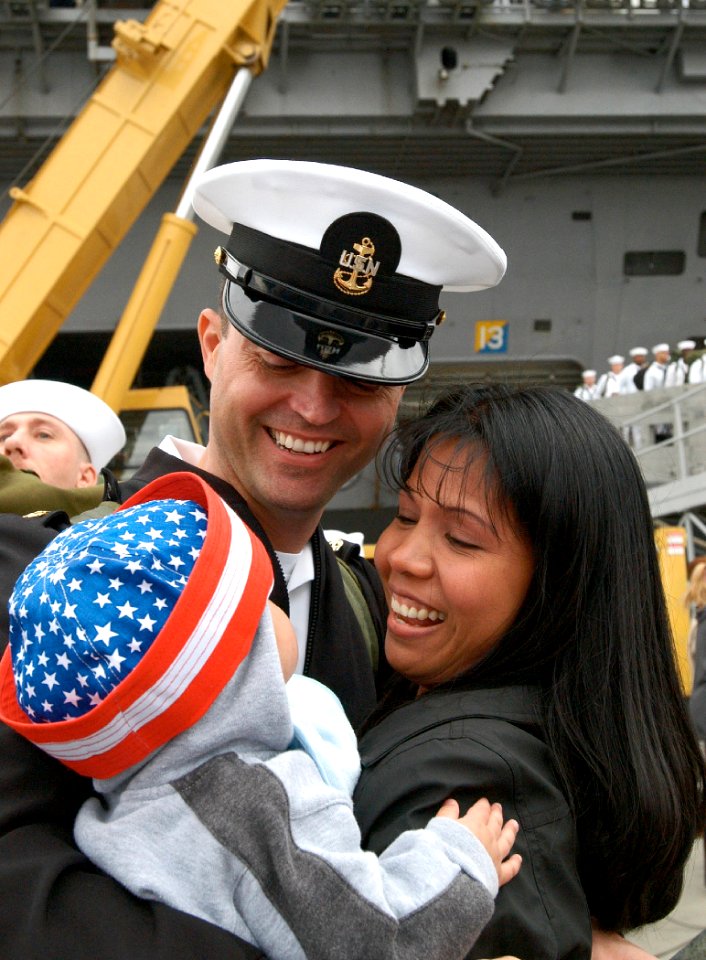 US Navy 030919-N-5362F-098 Navy Chief Petty Officer is greeted by his wife and child