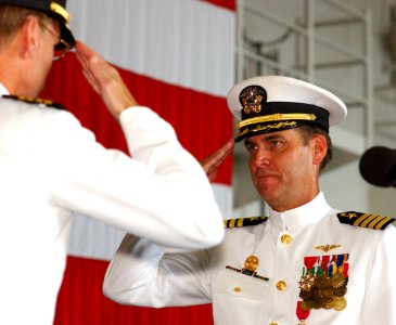 US Navy 030828-N-0696M-032 Capt. Bill Goodwin, right, salutes Capt. James Symonds signifying the official passing of duties and responsibilities to Capt. Symonds as Commanding Officer of USS Ronald Reagan (CVN 76)