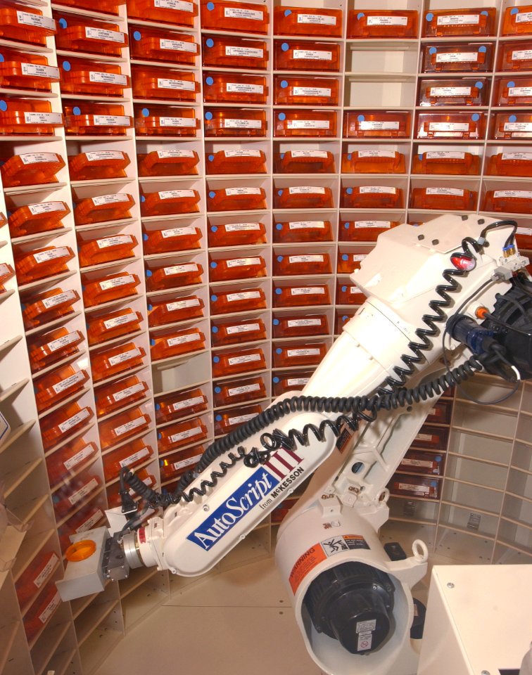 US Navy 030819-N-9593R-088 he Autoscript III, prescription filling robot, picks up a bin of medication at the National Naval Medical Center in Bethesda, Md