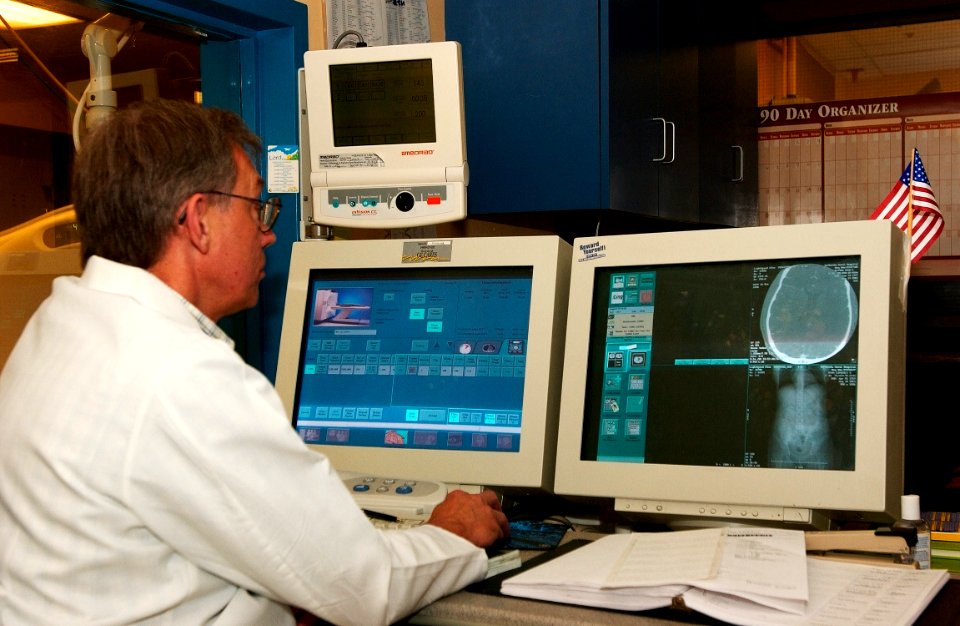 US Navy 030819-N-9593R-130 A civilian technician follows the progress of a CT Scan at the National Naval Medical Center in Bethesda, Maryland