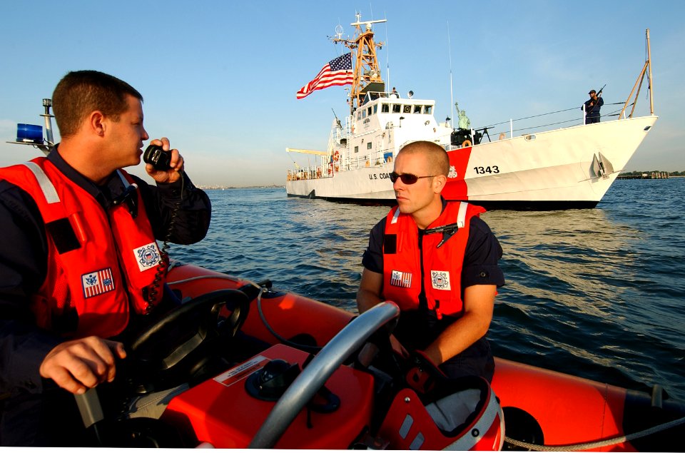 US Navy 030828-C-9409S-504 Boatswain's Mate 1st Class William Lappin, from Portland Me., talks by radio with the U.S. Coast Guard Cutter Bainbridge Island while on patrol in New York Harbor