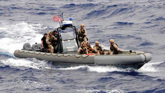 US Navy 100708-N-7058E-161 A visit, board, search and seizure team approaches USNS Bridge (T-AOE 10) in a rigid-hull inflatable boat