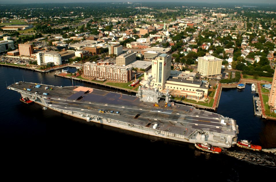 US Navy 030820-N-9851B-013 Tug boats guide USS Harry S. Truman (CVN 75) up the Elizabeth River, past Portsmouth landmarks, to the Norfolk Naval Shipyard