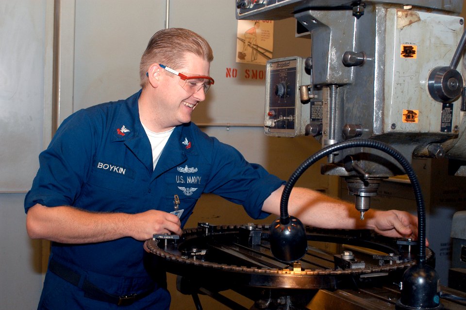 US Navy 031007-N-8770A-002 Machinist Repairman 2nd Class Sean Boykin tightens bolts on a positioning ring for motors within the Aviation Intermediate Maintenance Department