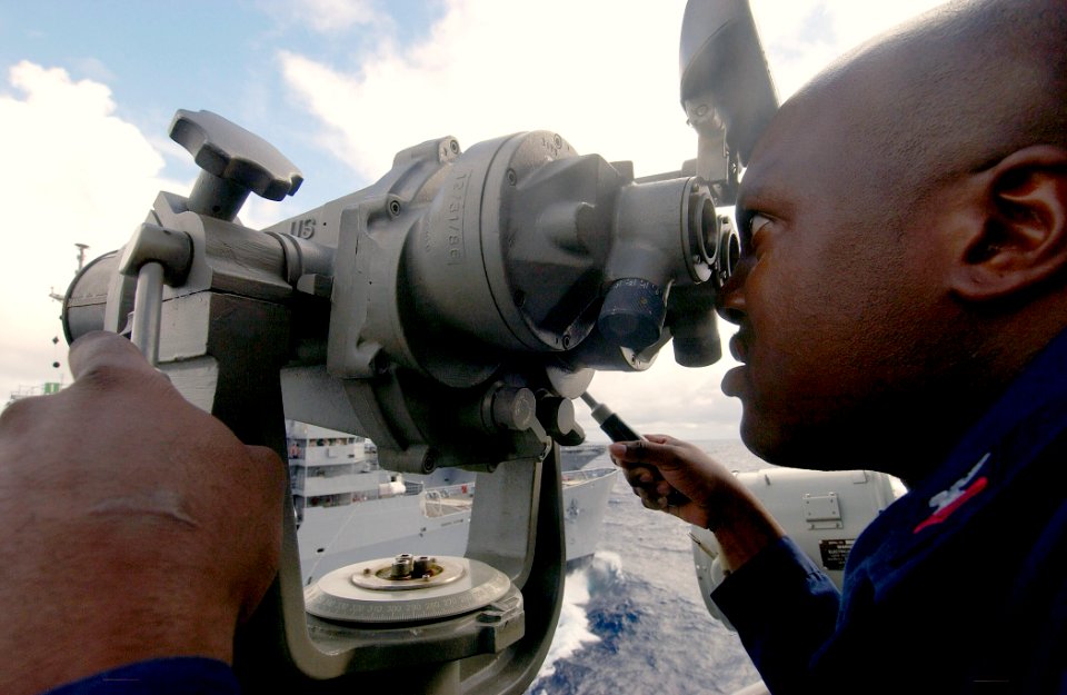 US Navy 030908-N-5471P-004 Signalman 2nd Class Olynthia Turner watches for communications from his counterparts aboard USS Enterprise (CVN 65) while USS Philippine Sea (CG 58) conducts a replenishment at sea