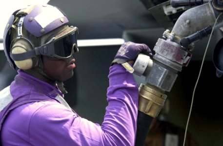 US Navy 030722-N-9319H-010 Airman Darrell White from Birmingham, Al., fuels an F-A-18E Super Hornet prior to flight operations on the flight deck of USS Nimitz (CVN 68)