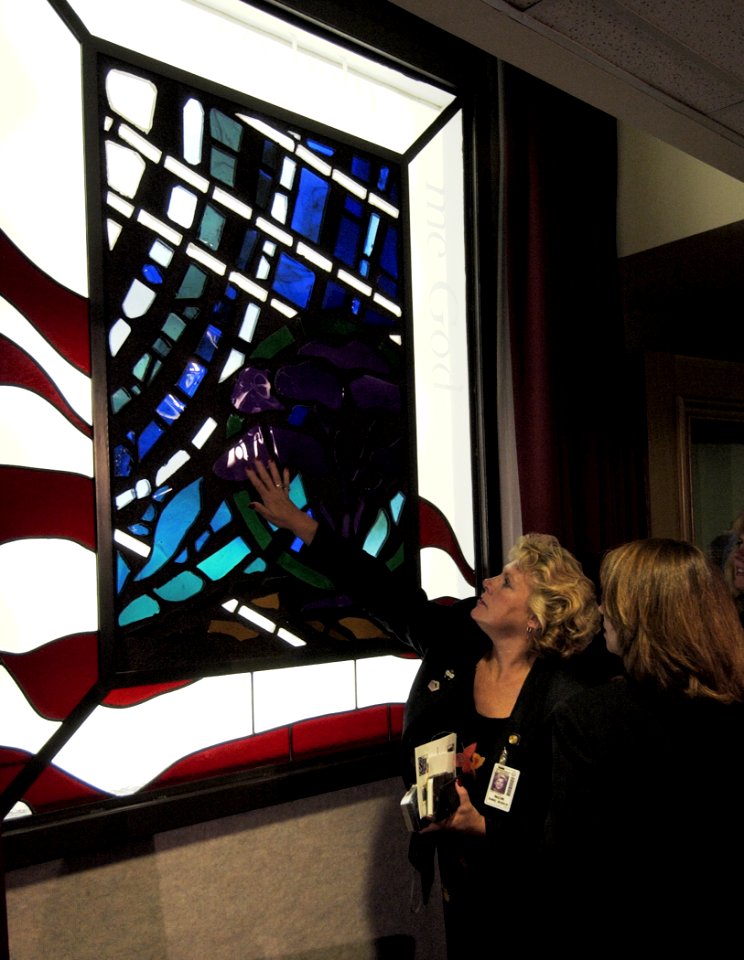 US Navy 030911-N-9593R-013 Guests at the dedication ceremony on Sept. 11, 2003 for stained glass windows built for the new Pentagon Chapel, touch pieces of the glass that they and their friends put into the art work