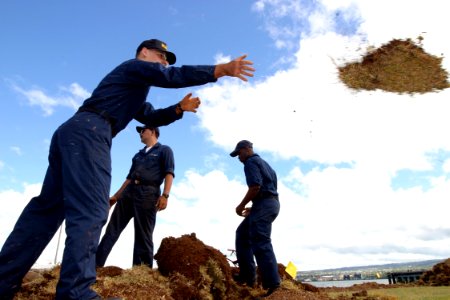 US Navy 030827-N-3228G-003 Seaman Eric Beitzel of Naval Station Pearl Harbor First Lieutenant Division throws sod the lawn of the USS Utah Memorial on Ford Island