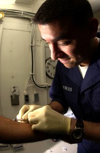 US Navy 030923-N-1577S-001 Hospital Corpsman 3rd Class Joseph Romero from Falfurrias, Texas, injects Purified Protein Derivative
