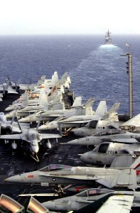 US Navy 030828-N-2143T-002 Various Navy aircraft are chocked and chained to the flight deck, as the guided missile cruiser USS Princeton (CG-59) steams forward of USS Nimitz (CVN 68) photo