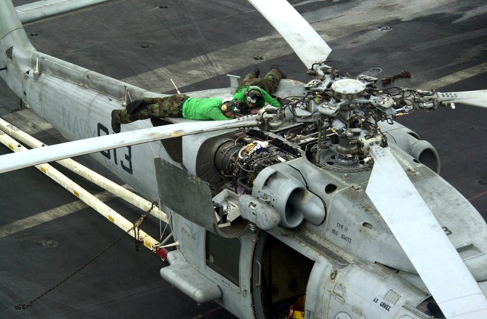 US Navy 030921-N-9319H-002 Aviation Machinist's Mate 3rd Class Joseph Minneman removes an axial fan assembly