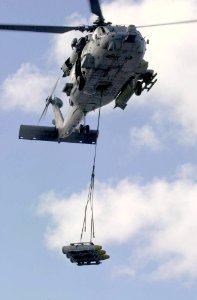 US Navy 031023-N-2385R-006 An HH-60H Seahawk assigned to the Indians of Helicopter Antisubmarine Warfare Squadron Six (HS-6) transports ordnance from USS Nimitz's (CVN 68) to USNS Kilauea (T-AE 26)