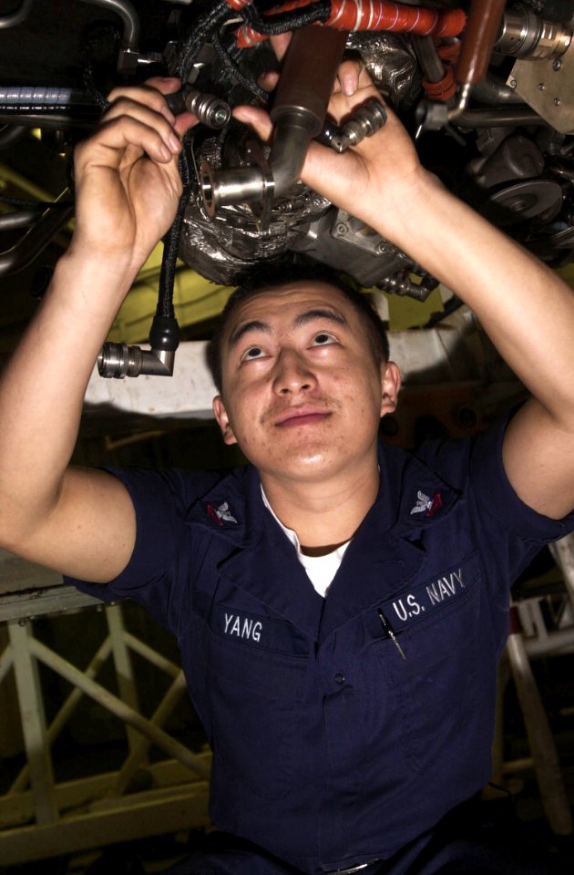US Navy 030922-N-2385R-003 Aviation Machinist's Mate 2nd Class Chou Yang from Braselton, Ga., inspects the routing cables